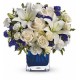 Composition of glass of a dozen white roses and blue flowers