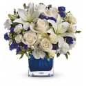 Composition of glass of a dozen white roses and blue flowers